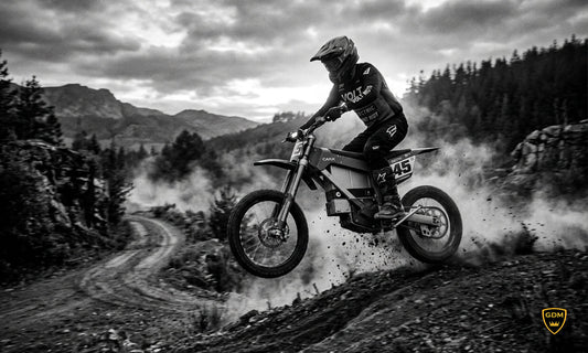 Rider in a GDM dual sport helmet on an electric dirt bike